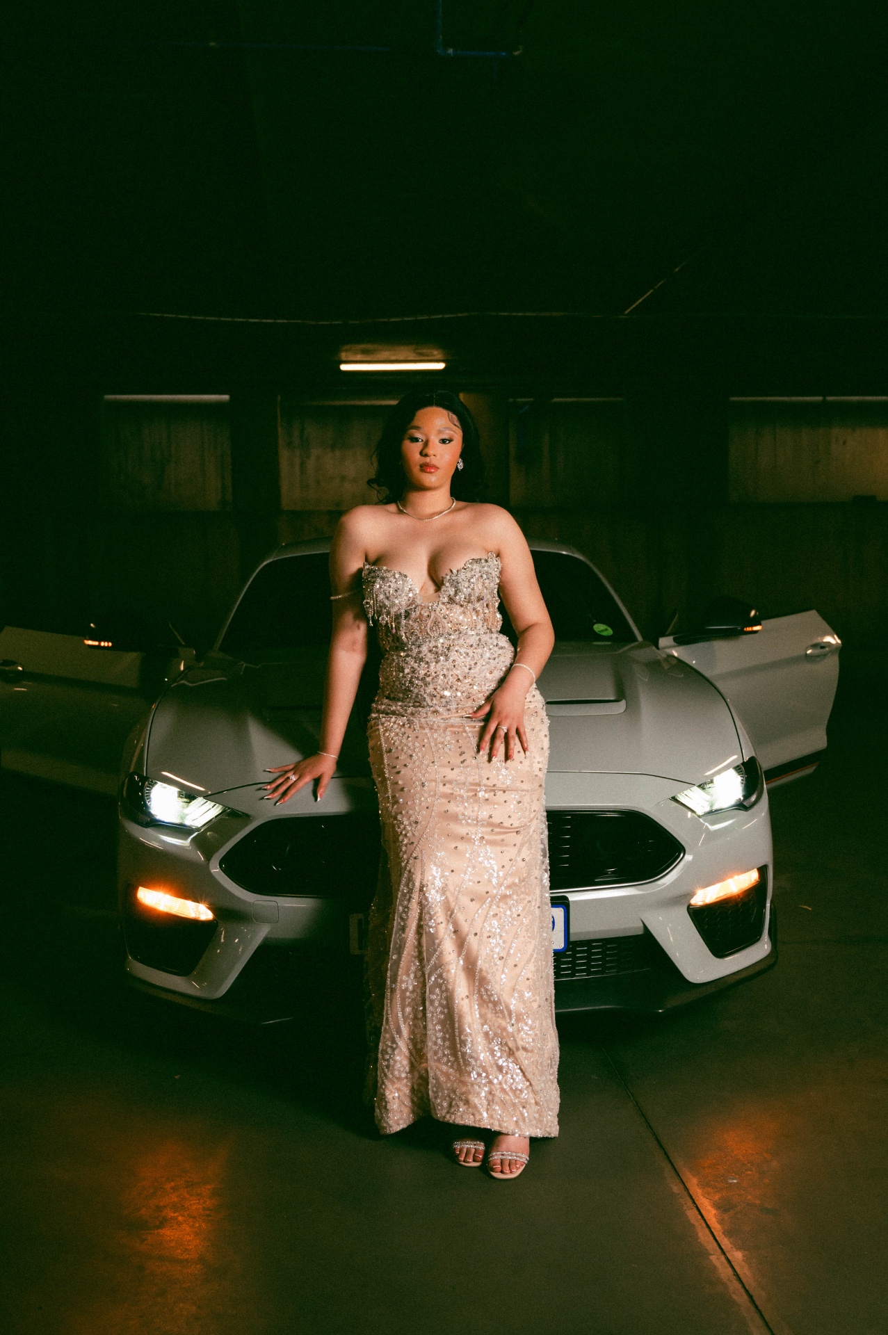 Sparkling gown beside white Mustang